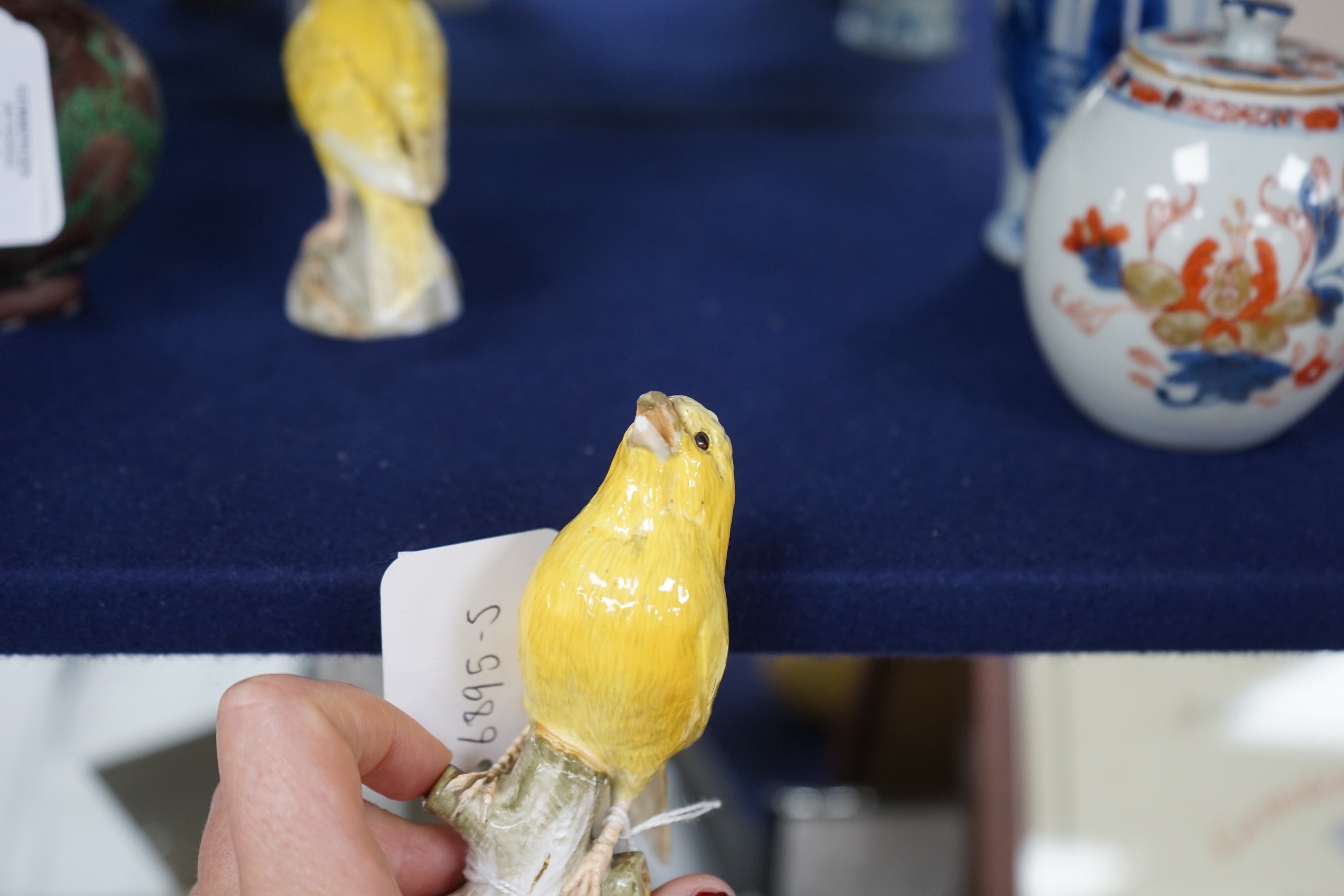 A pair of Meissen figures of canaries, 10cm tall